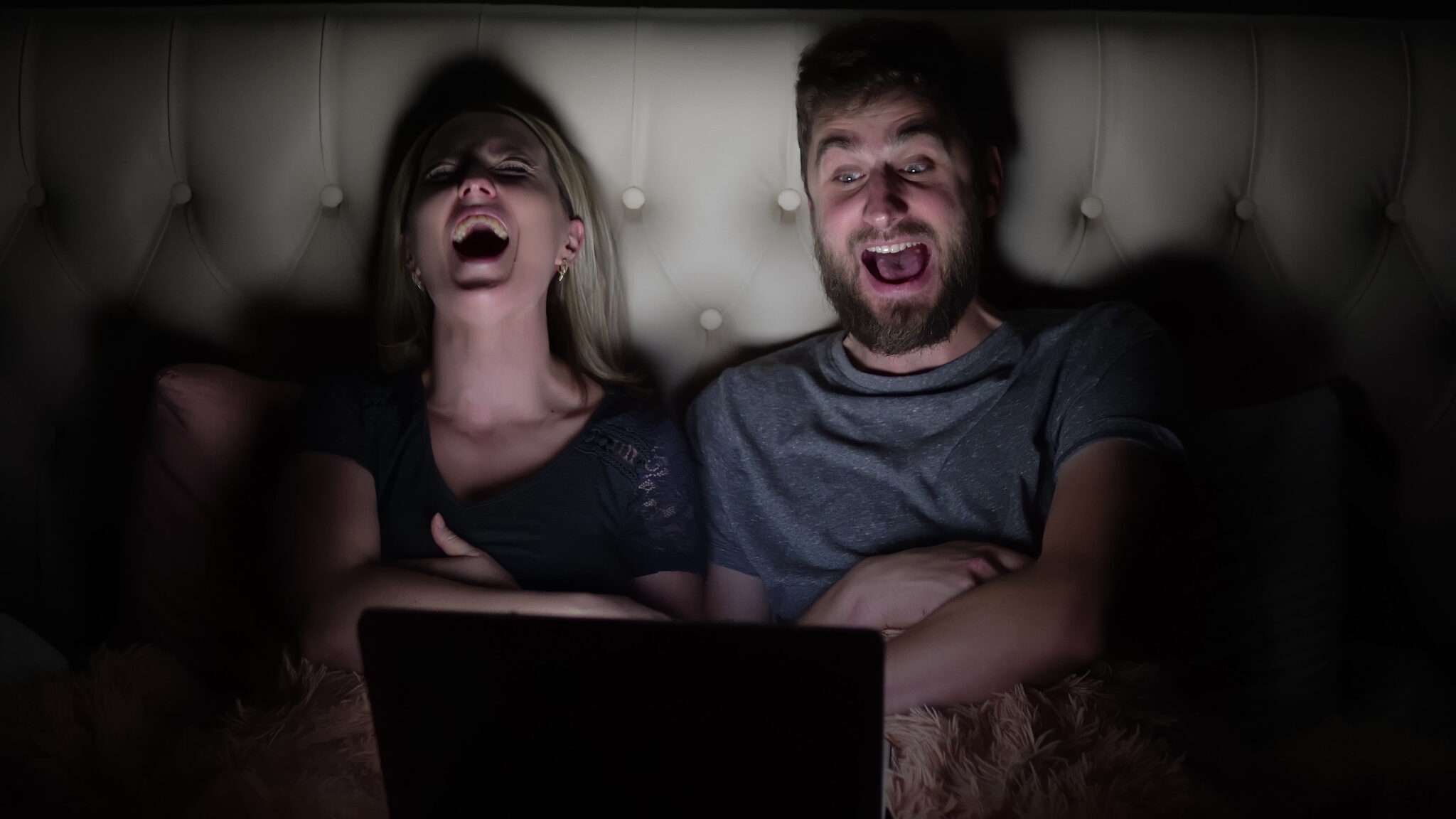 フランスでラップトップで映画を観ながら笑っているカップル。 フランスでラップトップで映画を観ながら笑っているカップル。