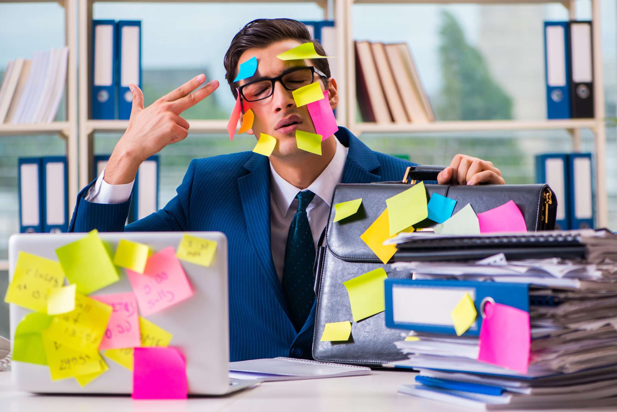 顔に付箋とフランスをイメージしたステッカーを貼ったスーツを着た男性。