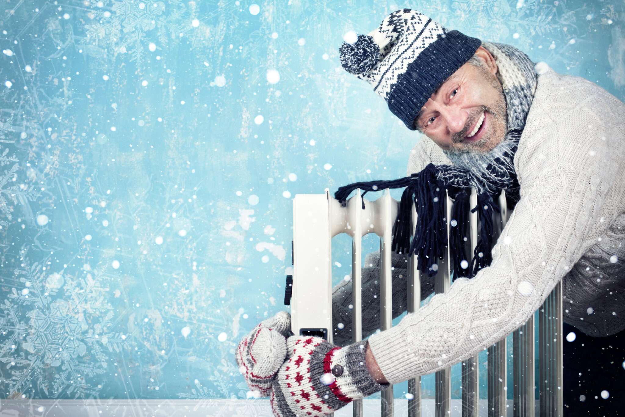 フランスの冬、ラジエーターにもたれかかる男性。