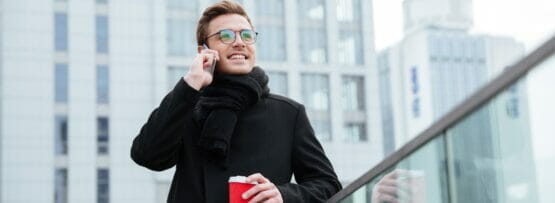 フランスでコーヒーを飲みながら電話で話している男性。