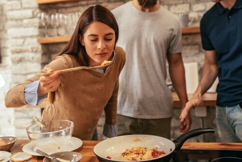 フランスのキッチンで食事を準備する人々のグループ。