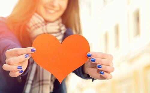 Female,Hands,Close,Up.,Red,Heart,In,The,Hands.,Woman