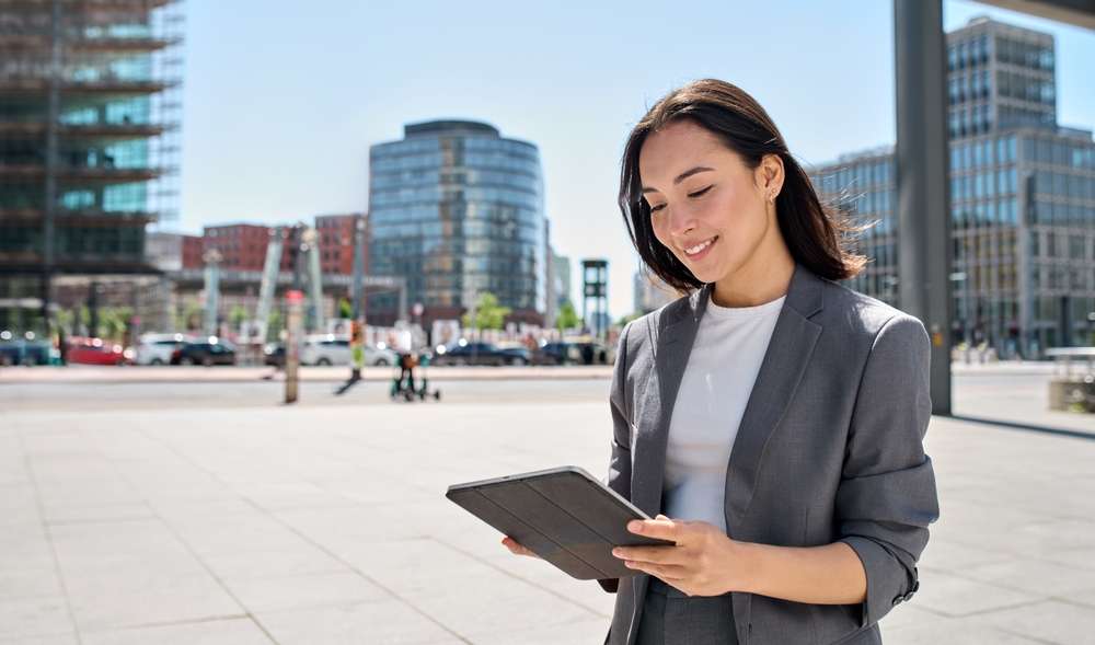 街中でタブレットを使うフランス人ビジネスウーマン。